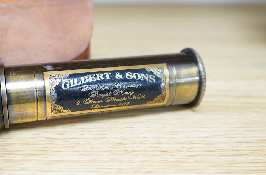 A reproduction 19th century style brass kaleidoscope with panel reading; ‘Gilbert & Sons To Her Majesty’s Royal Navy, 8 Street Black Wall, London 1895’, 13.5cm long, in a leather case, together with a wood cased brass so